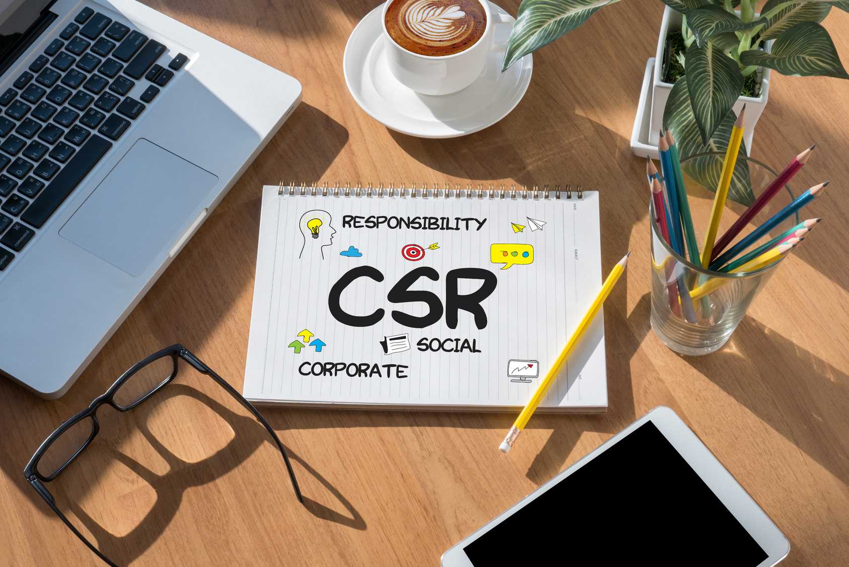 Corporate Social Responsibility CSR and Sustainability Responsible Office CSR open book on table and coffee Business